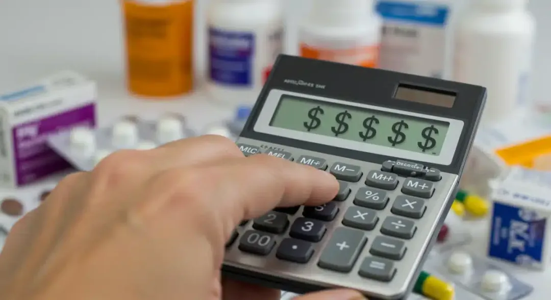 Calculator showing savings next to prescription drug boxes, representing cost reduction