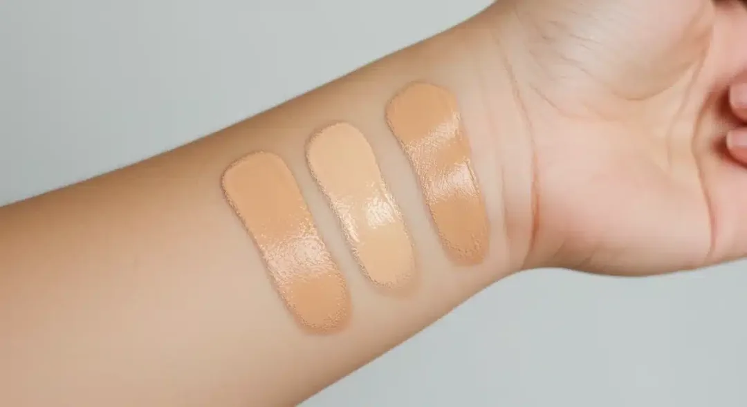 Swatch testing foundation shades on the jawline to find the perfect match.