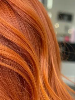 Woman with warm copper hair color showcasing 2026 trend